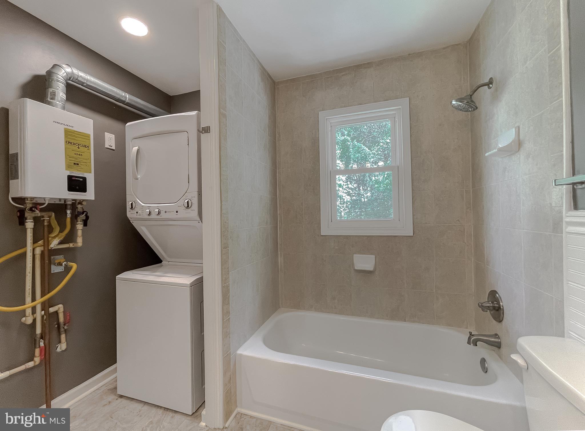 1607 Beech Road St. Leonard, MD 20685 - Photo 29 of 33 a bathroom with a bathtub sink and window