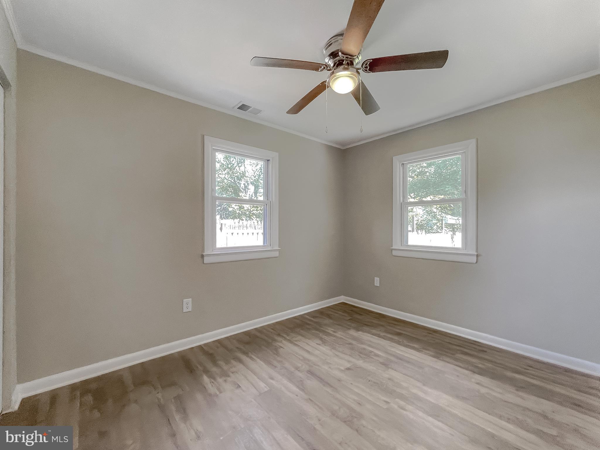1607 Beech Road St. Leonard, MD 20685 - Photo 30 of 33 a view of empty room with wooden floor and fan