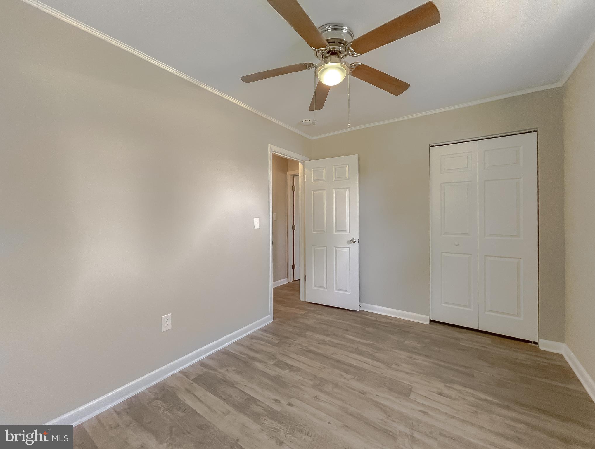 1607 Beech Road St. Leonard, MD 20685 - Photo 32 of 33 an empty room with wooden floor fan and windows
