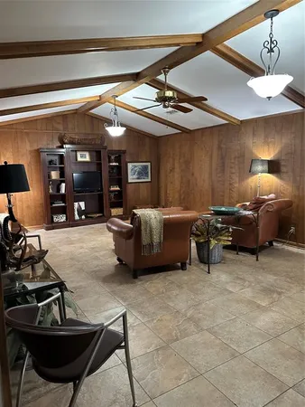a living room with furniture a couch and a flat screen tv