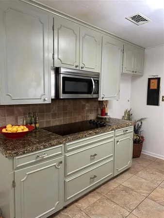 a kitchen with stainless steel appliances granite countertop a sink stove and microwave