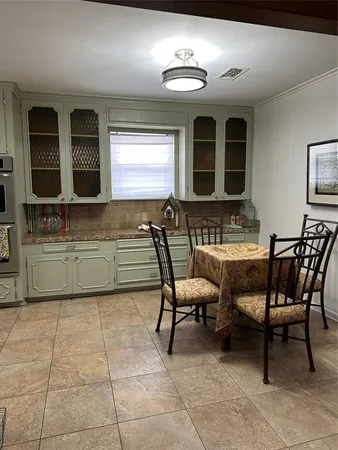 a kitchen with a sink and a stove top oven