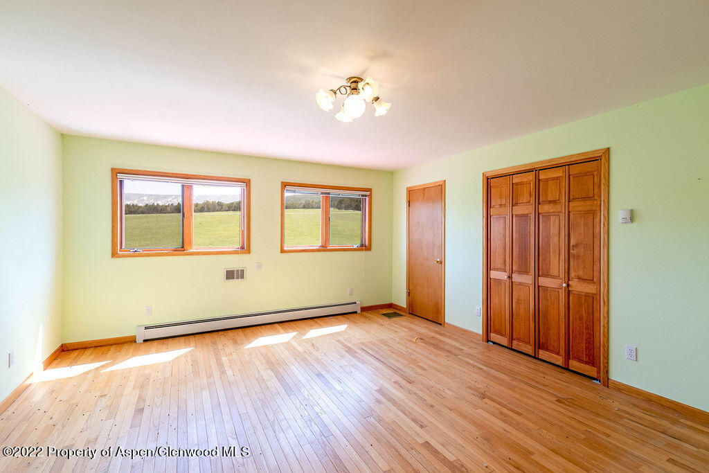 47417 KE Road Mesa, CO 81643 - Photo 11 of 40 a view of an empty room with wooden floor and a window