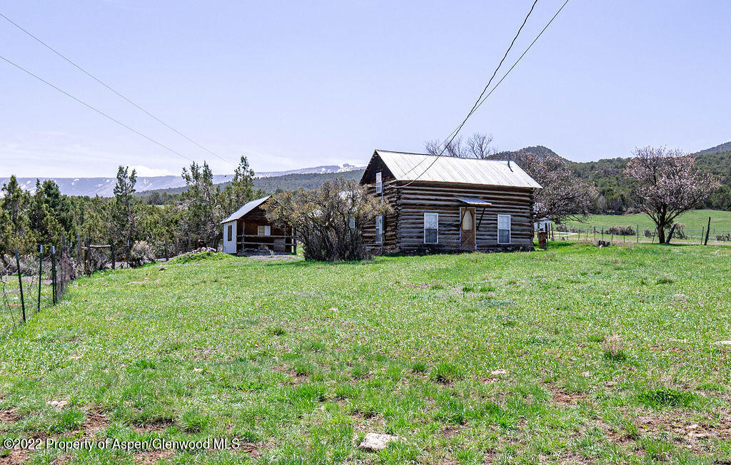 47417 KE Road Mesa, CO 81643 - Photo 14 of 40 a view of a house with a big yard and large trees