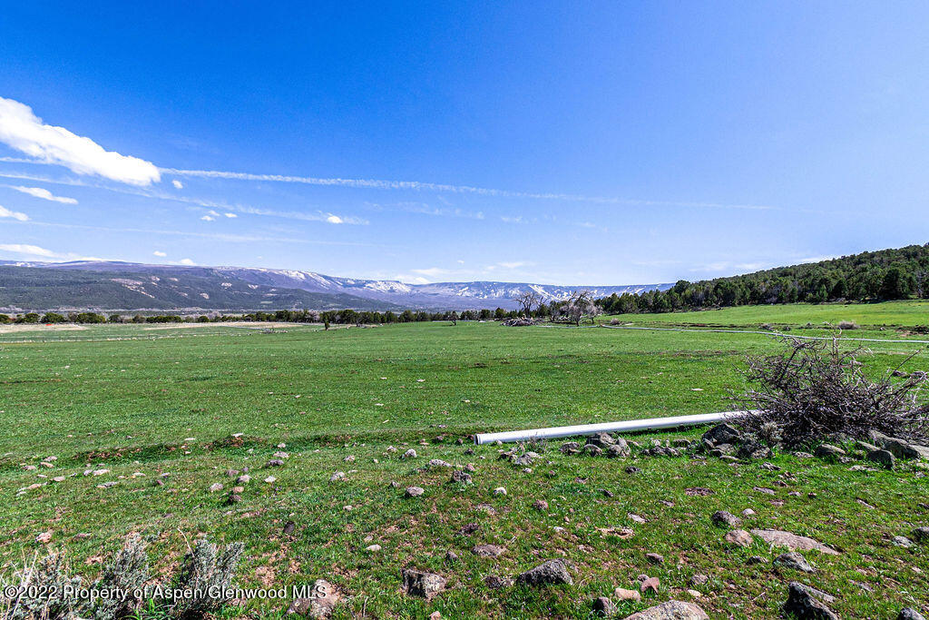 47417 KE Road Mesa, CO 81643 - Photo 36 of 40 a view of a field with an house in the background