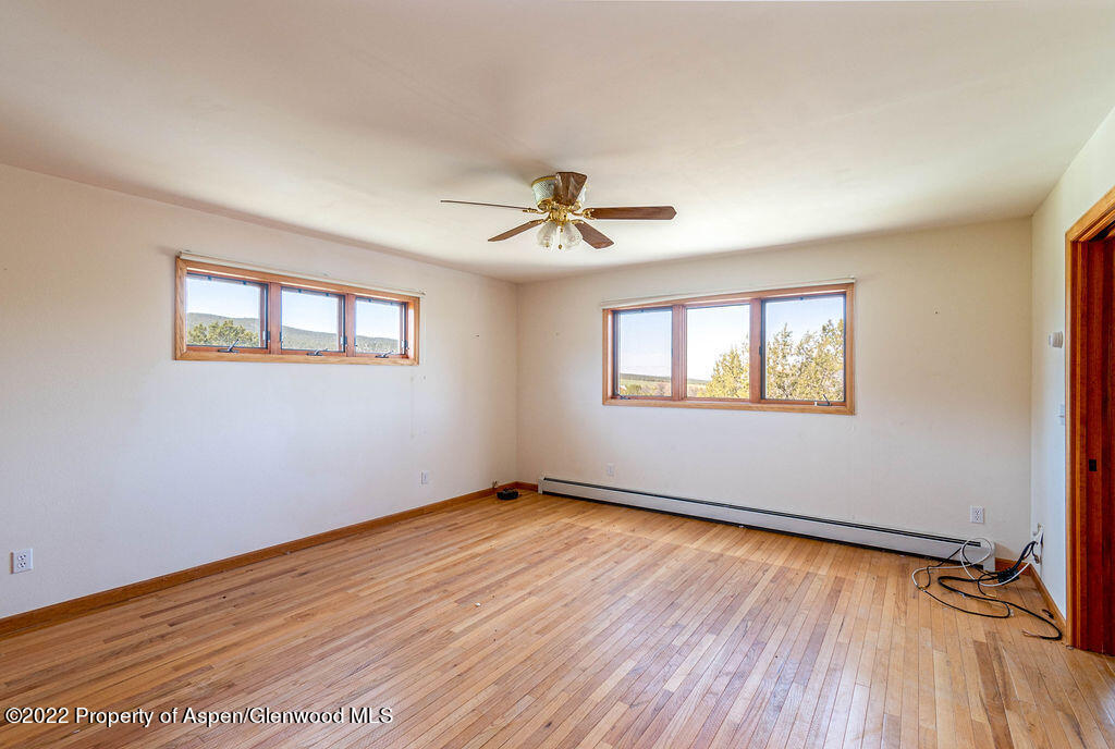 47417 KE Road Mesa, CO 81643 - Photo 6 of 40 a view of a room with wooden floor and a ceiling fan