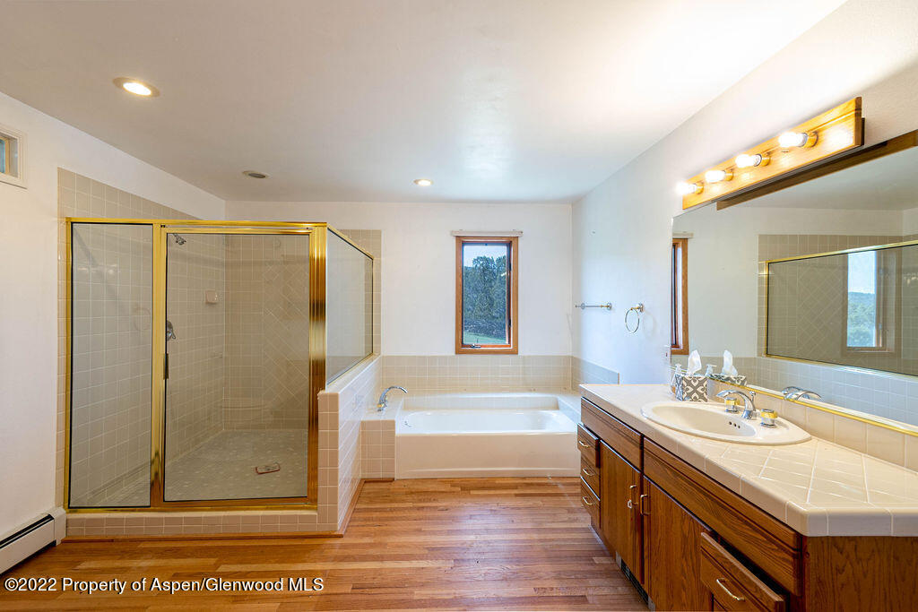 47417 KE Road Mesa, CO 81643 - Photo 7 of 40 a bathroom with a granite countertop sink a mirror and shower