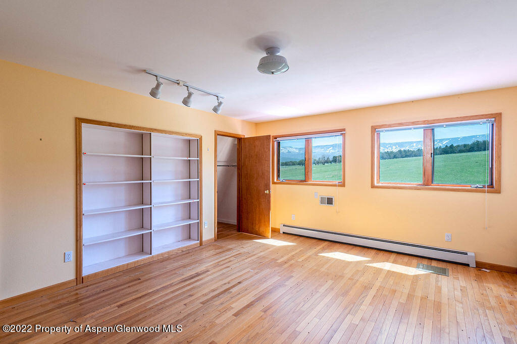 47417 KE Road Mesa, CO 81643 - Photo 8 of 40 a view of an empty room with a window and wooden floor