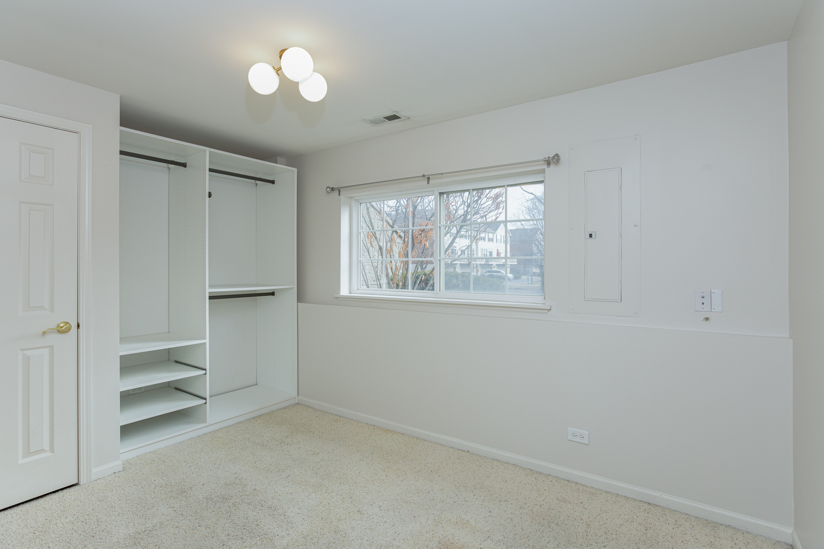 720 Thornbury Road Bartlett, IL 60103 - Photo 14 of 24 an empty room with a window and a ceiling fan