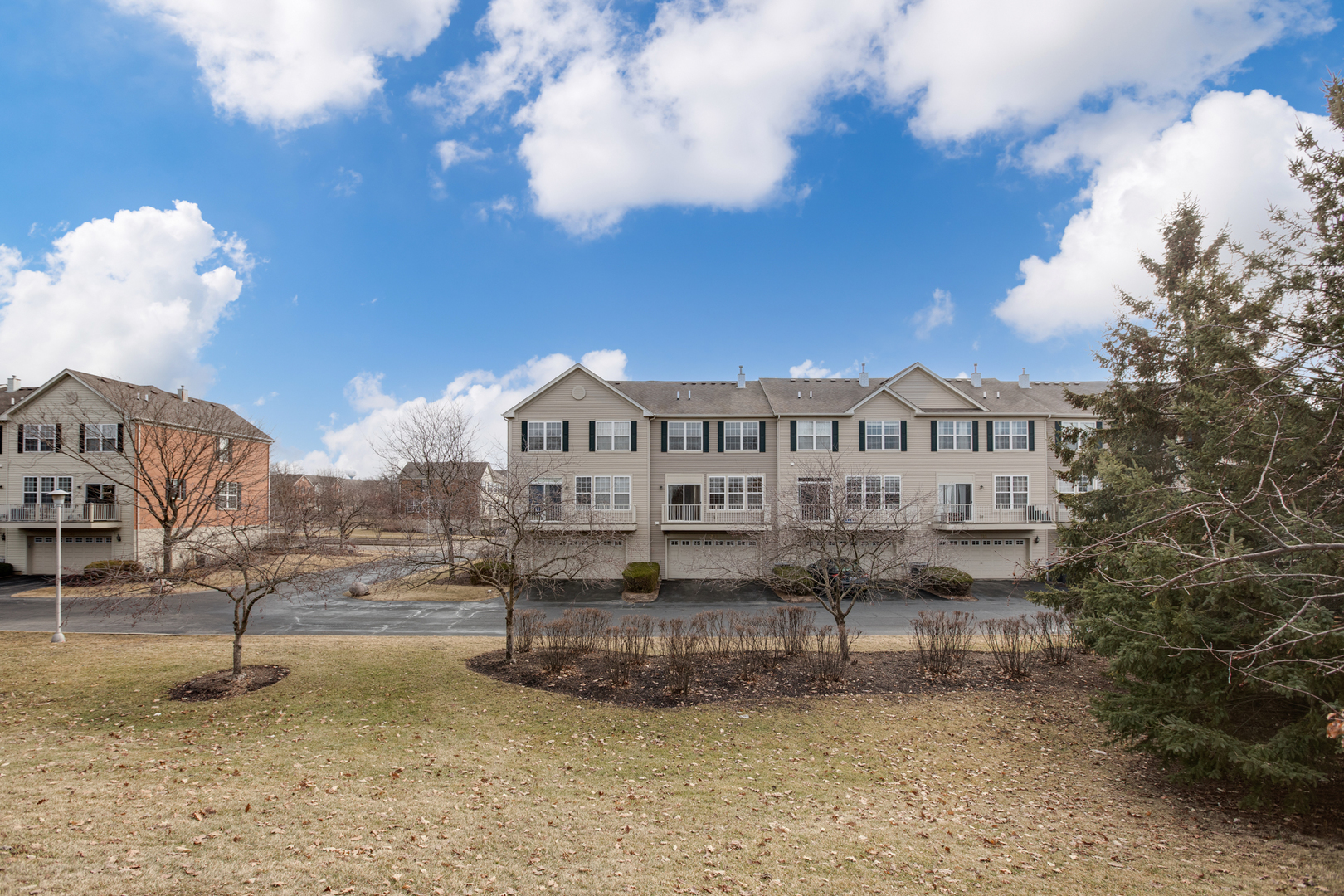 720 Thornbury Road Bartlett, IL 60103 - Photo 2 of 24 a view of a big building with wooden fence