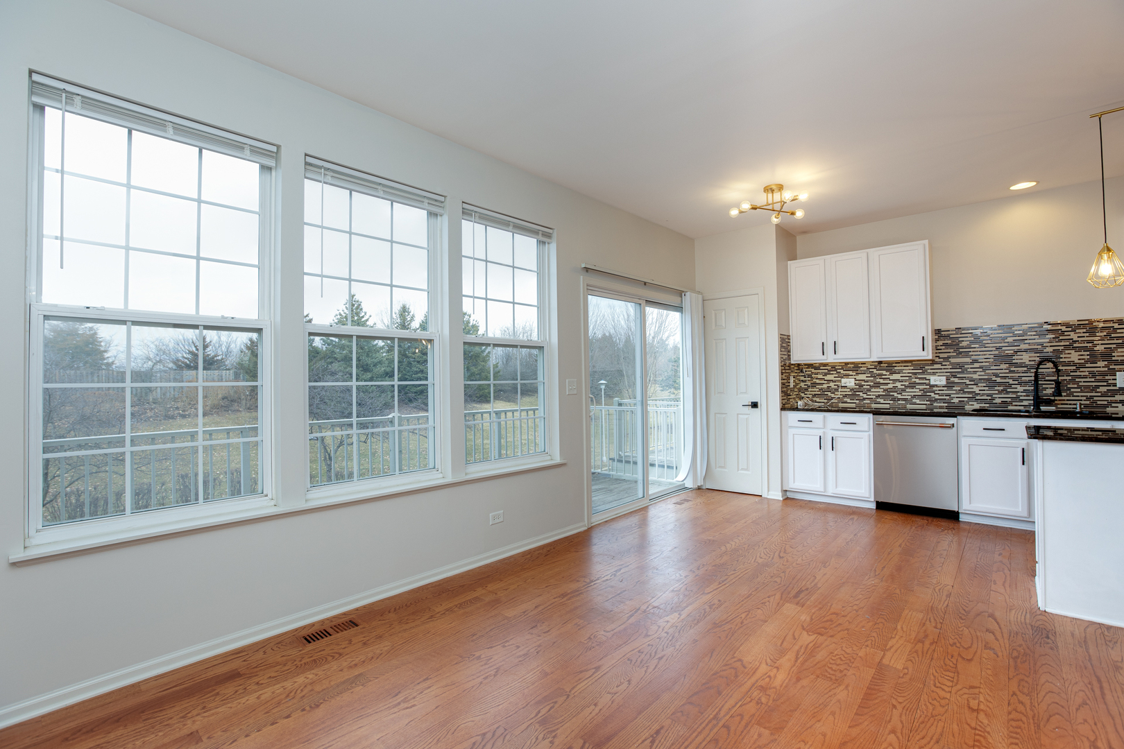720 Thornbury Road Bartlett, IL 60103 - Photo 5 of 24 a large open kitchen with granite countertop a stove a sink and a large window