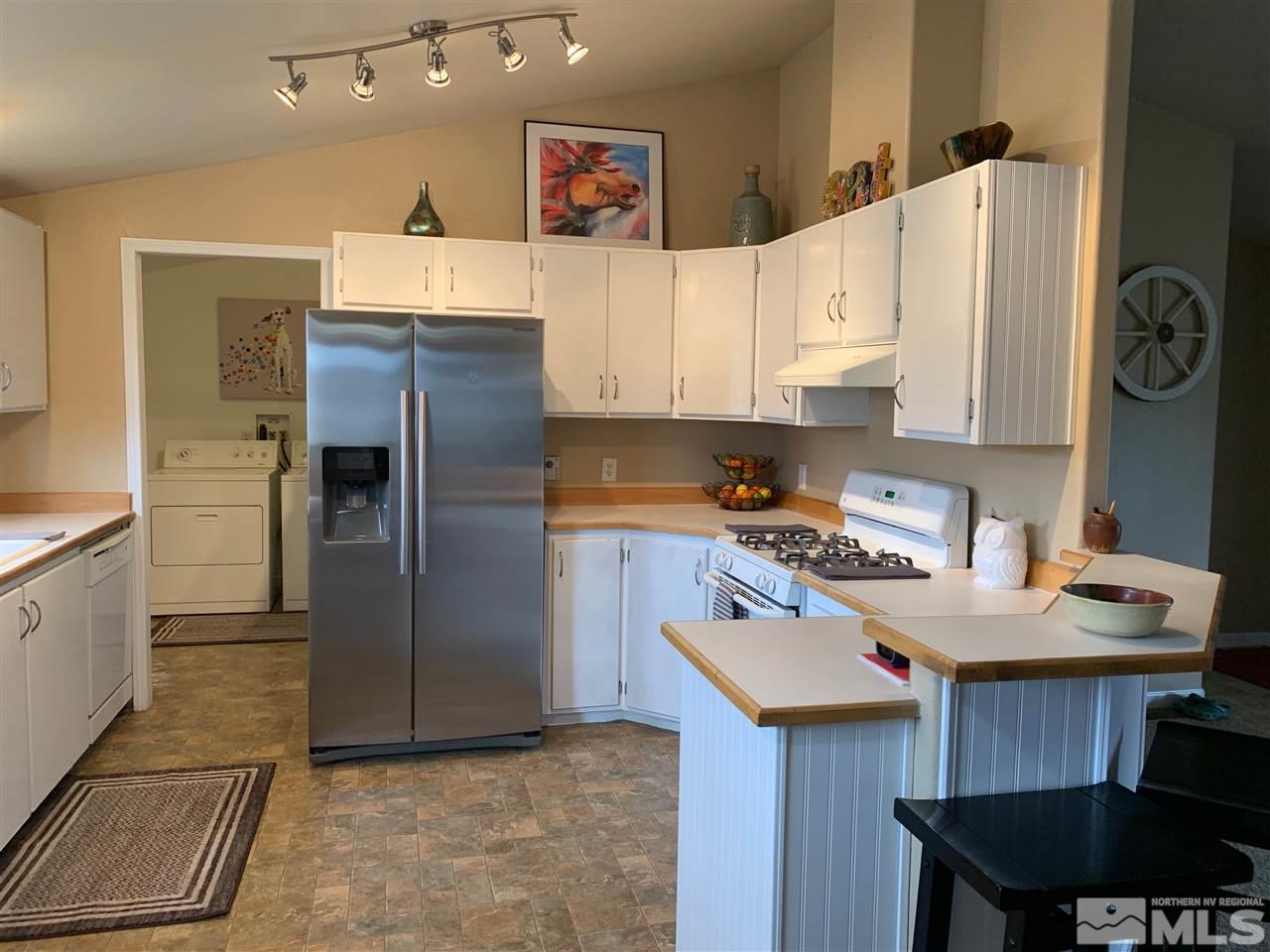 17385 Whippoorwill Lane Reno, NV 89508 - Photo 4 of 17 a kitchen with a refrigerator and a stove top oven