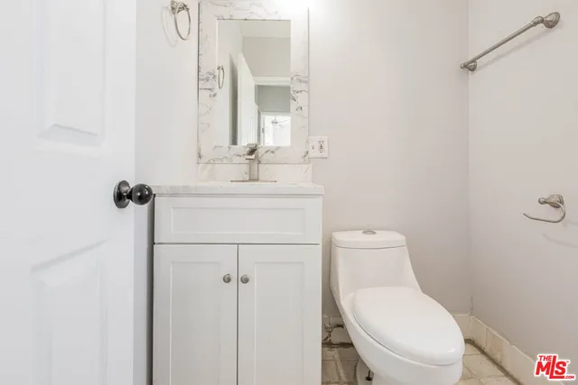 a kitchen with kitchen island granite countertop a sink cabinets and stainless steel appliances