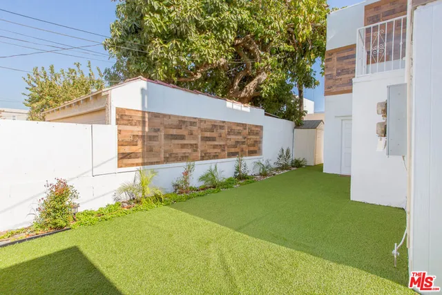 a view of a house with a car parked in front of a house
