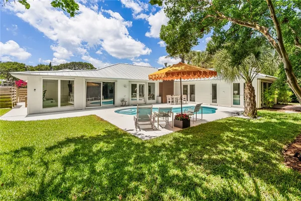 a view of a house with a yard patio and fire pit