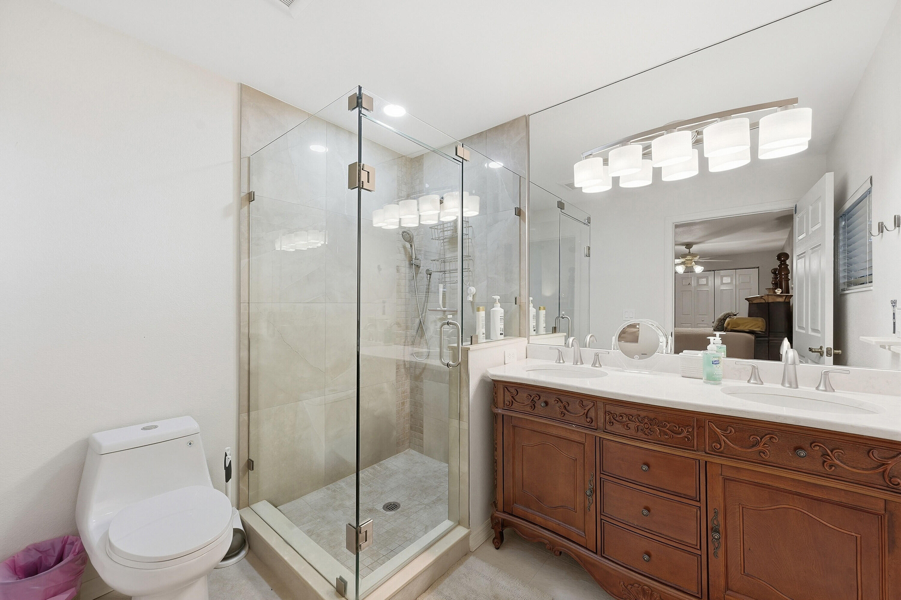 200 Windy Point Road Lake Placid, FL 33852 - Photo 13 of 74 a bathroom with a double vanity sink toilet mirror and shower