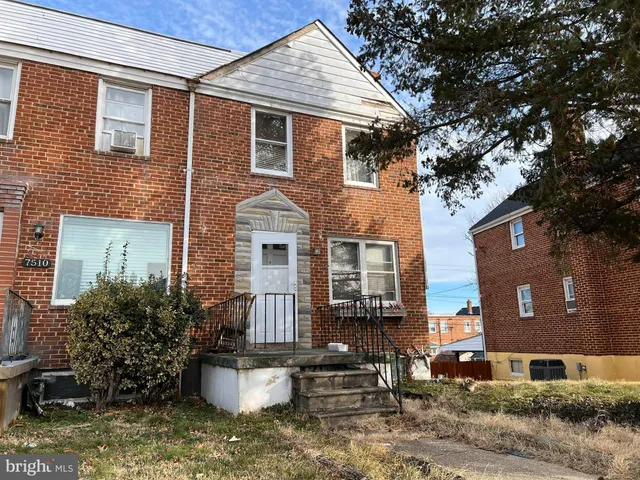a front view of a house with sitting area