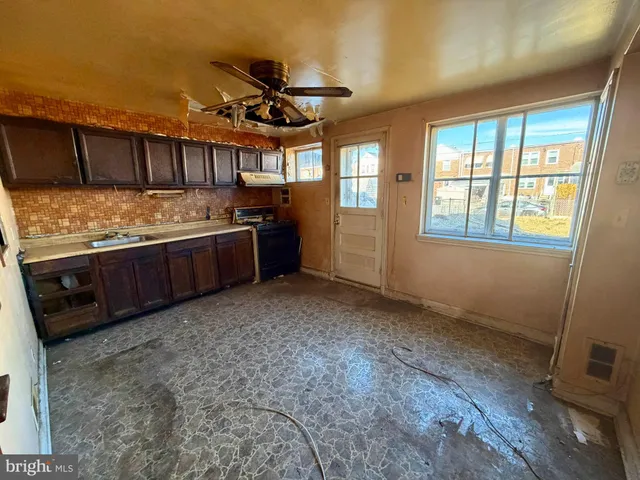 a living room with granite countertop furniture a ceiling fan and a window