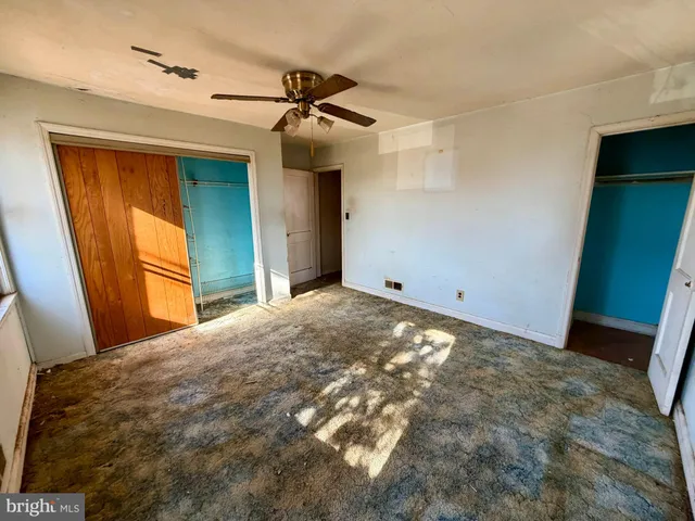 a bedroom with a bed and a mirror