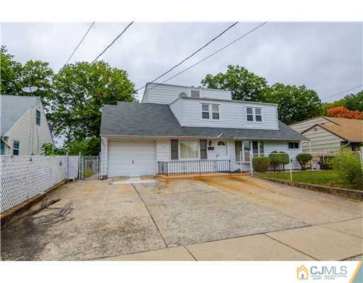 112 Idlewild Road Edison, NJ 08817 - Photo 1 of 20 a front view of a house with a yard and garage