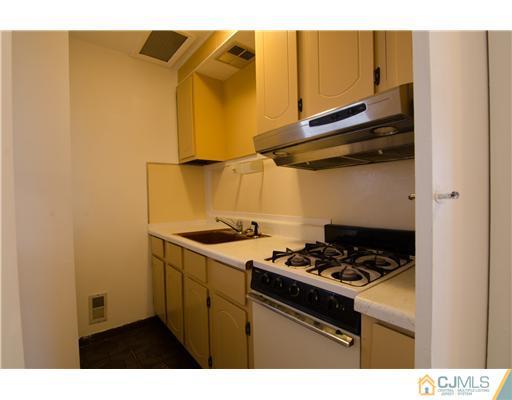 112 Idlewild Road Edison, NJ 08817 - Photo 13 of 20 a kitchen with a stove and a refrigerator