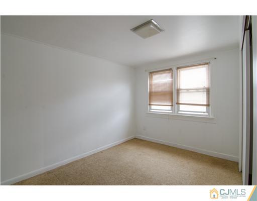 112 Idlewild Road Edison, NJ 08817 - Photo 14 of 20 a view of an empty room with a window