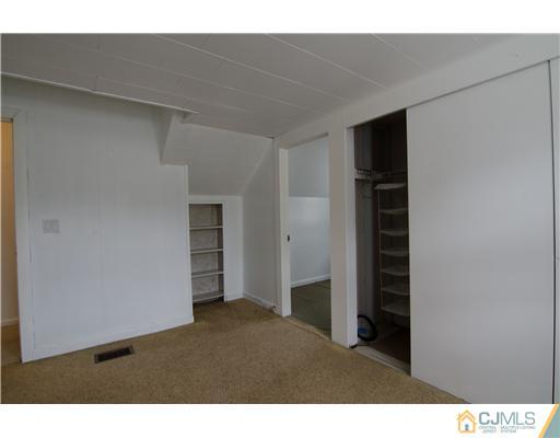 112 Idlewild Road Edison, NJ 08817 - Photo 17 of 20 a room with closet and windows