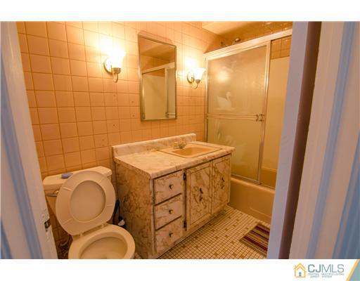 112 Idlewild Road Edison, NJ 08817 - Photo 10 of 20 a bathroom with a granite countertop sink toilet and shower
