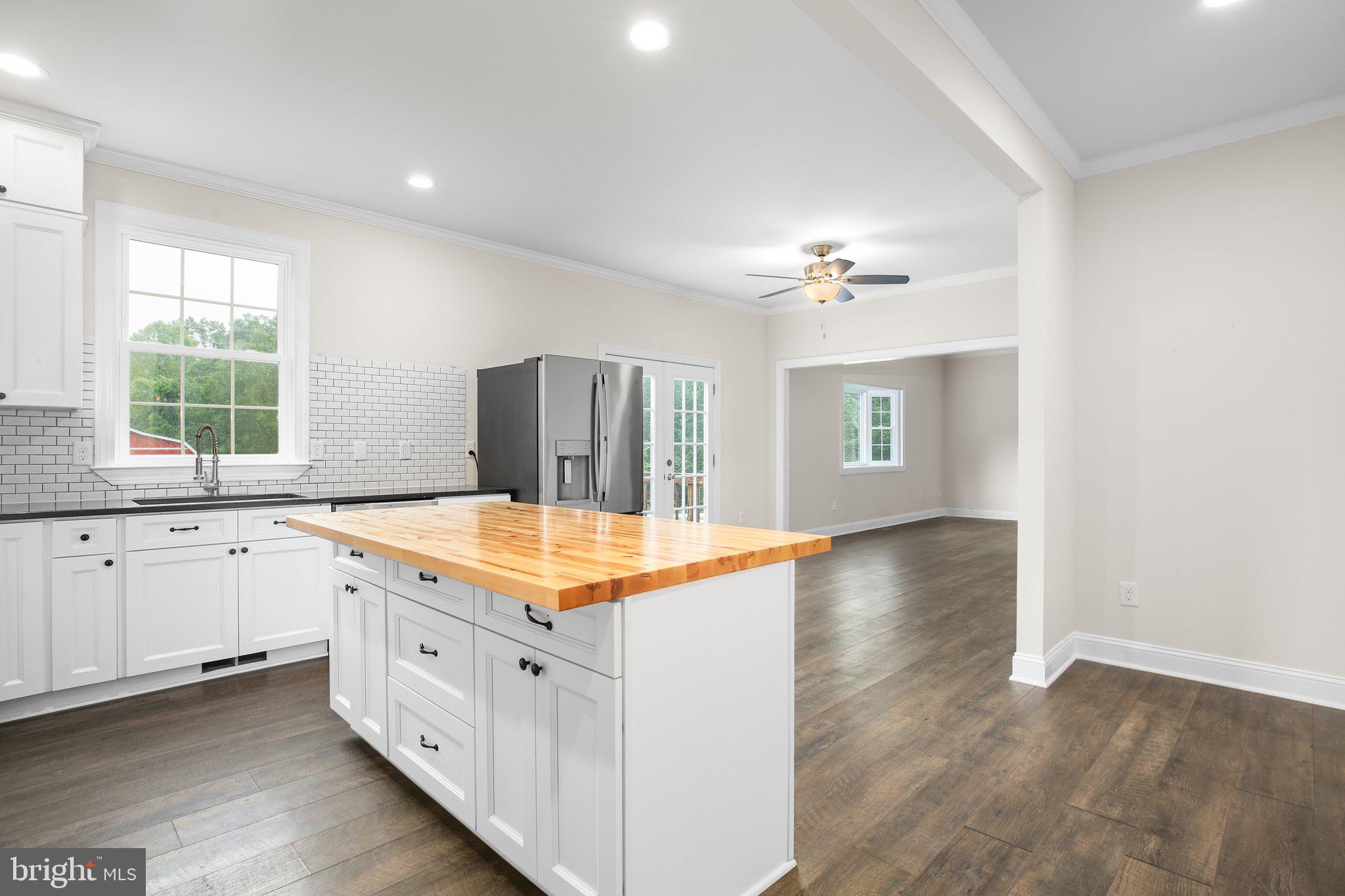 6337 Louisianna Road Locust Grove, VA 22508 - Photo 16 of 75 a room with granite countertop a sink and dishwasher with wooden floor