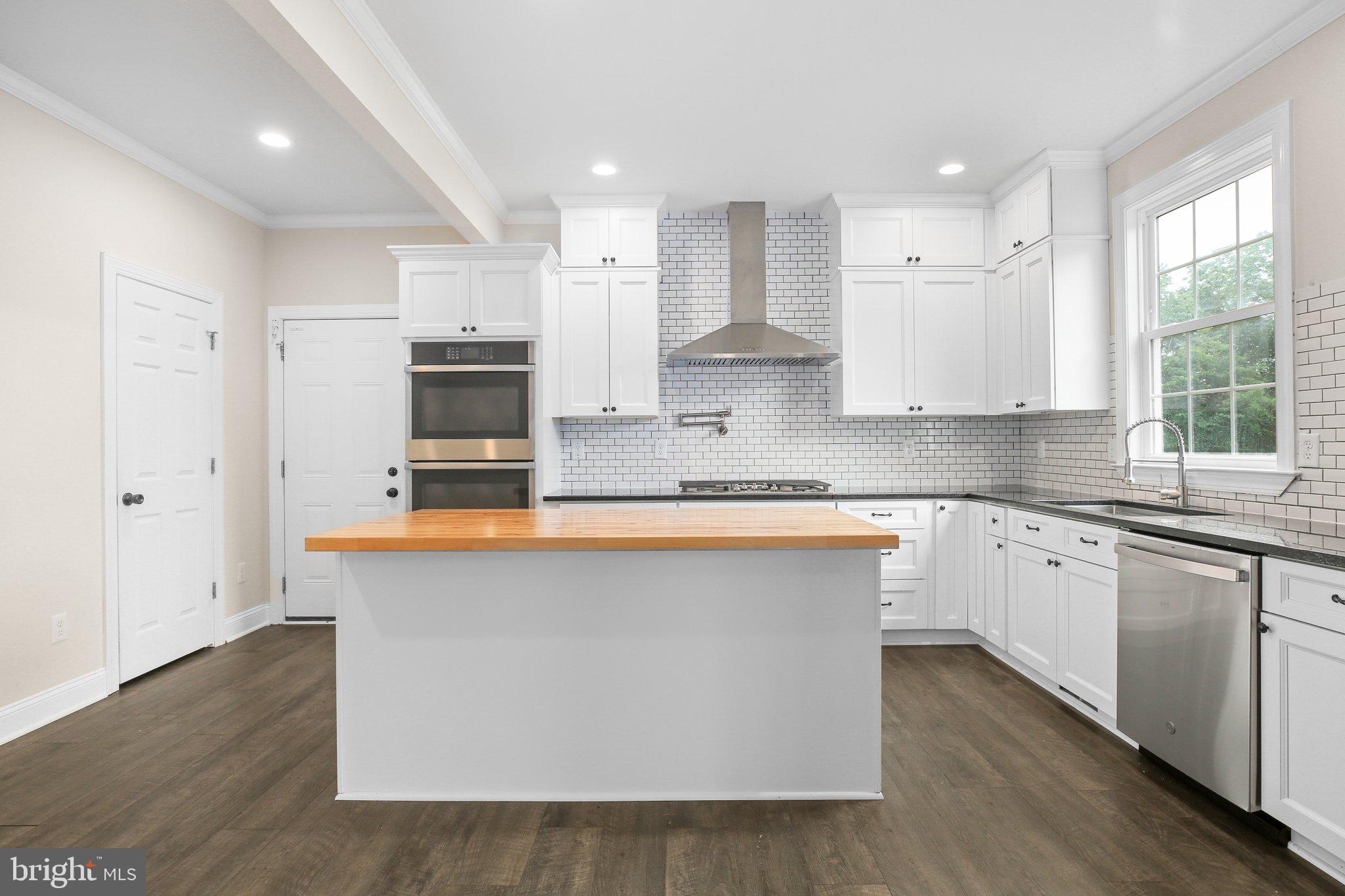 6337 Louisianna Road Locust Grove, VA 22508 - Photo 20 of 75 a large kitchen with stainless steel appliances granite countertop a stove a sink and a white wooden cabinets