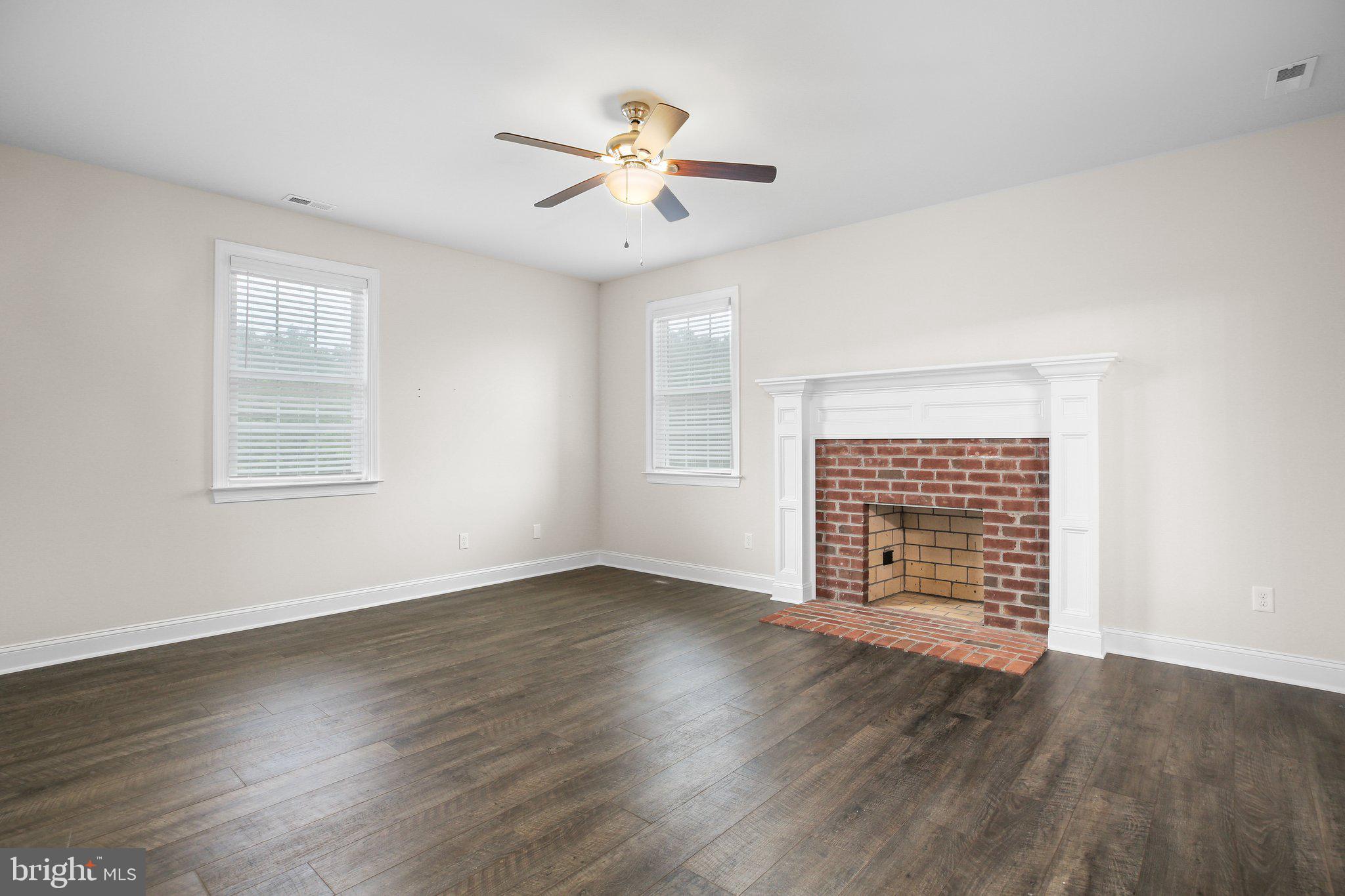 6337 Louisianna Road Locust Grove, VA 22508 - Photo 38 of 75 an empty room with wooden floor chandelier fan and windows