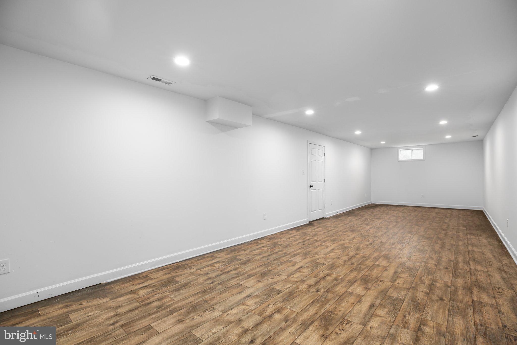 6337 Louisianna Road Locust Grove, VA 22508 - Photo 47 of 75 an empty room with wooden floor and white walls