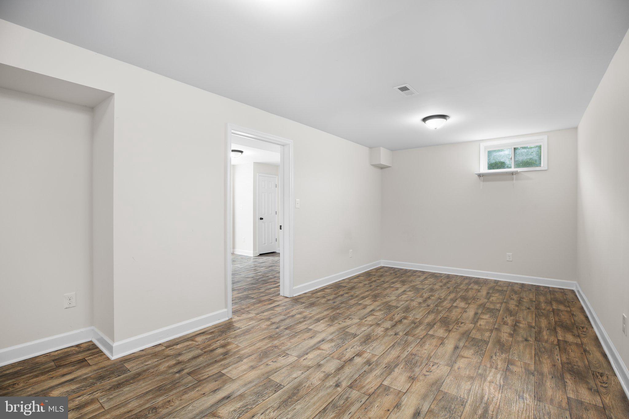 6337 Louisianna Road Locust Grove, VA 22508 - Photo 48 of 75 an empty room with wooden floor and windows