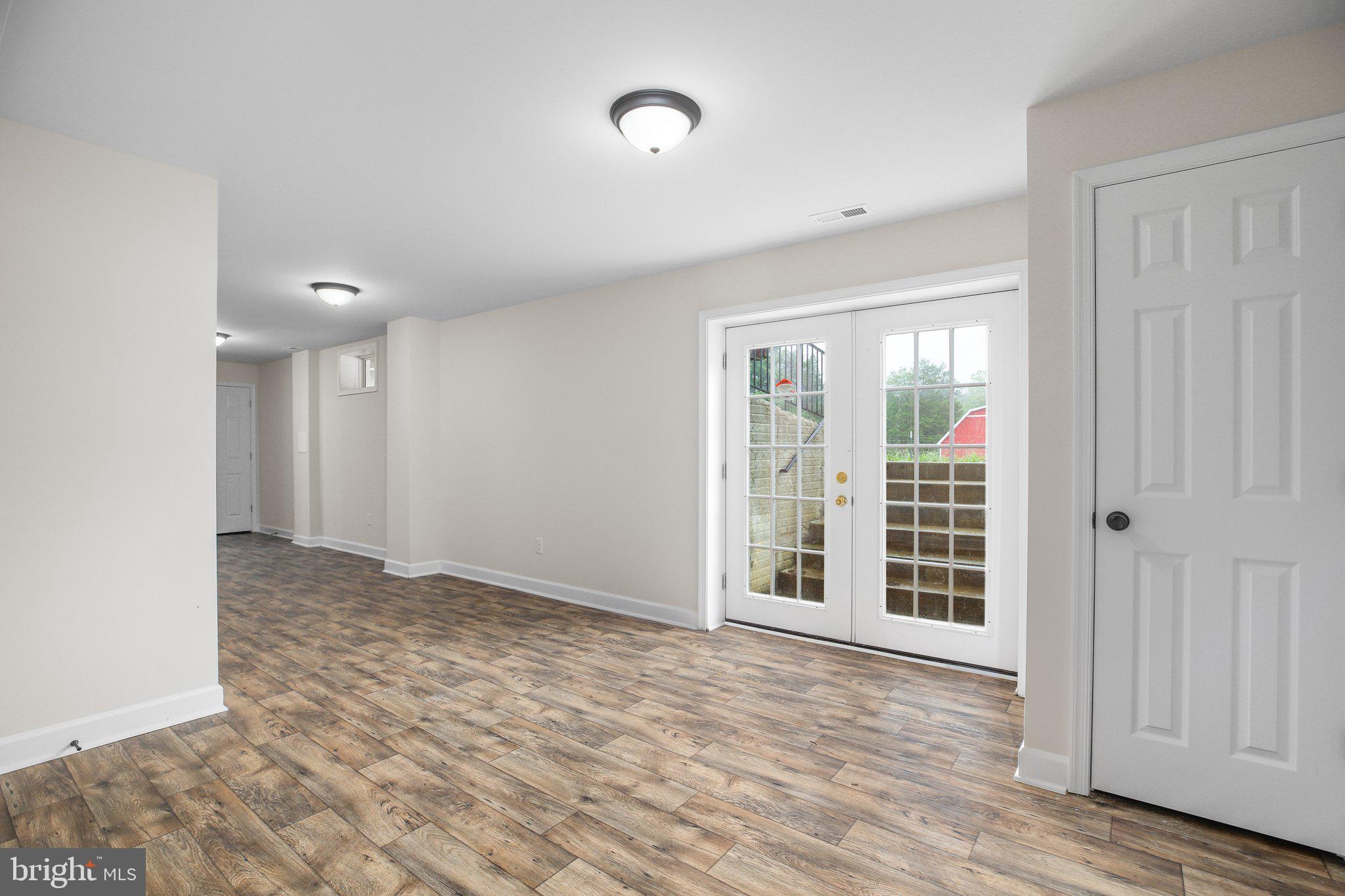 6337 Louisianna Road Locust Grove, VA 22508 - Photo 51 of 75 an empty room with wooden floor and windows