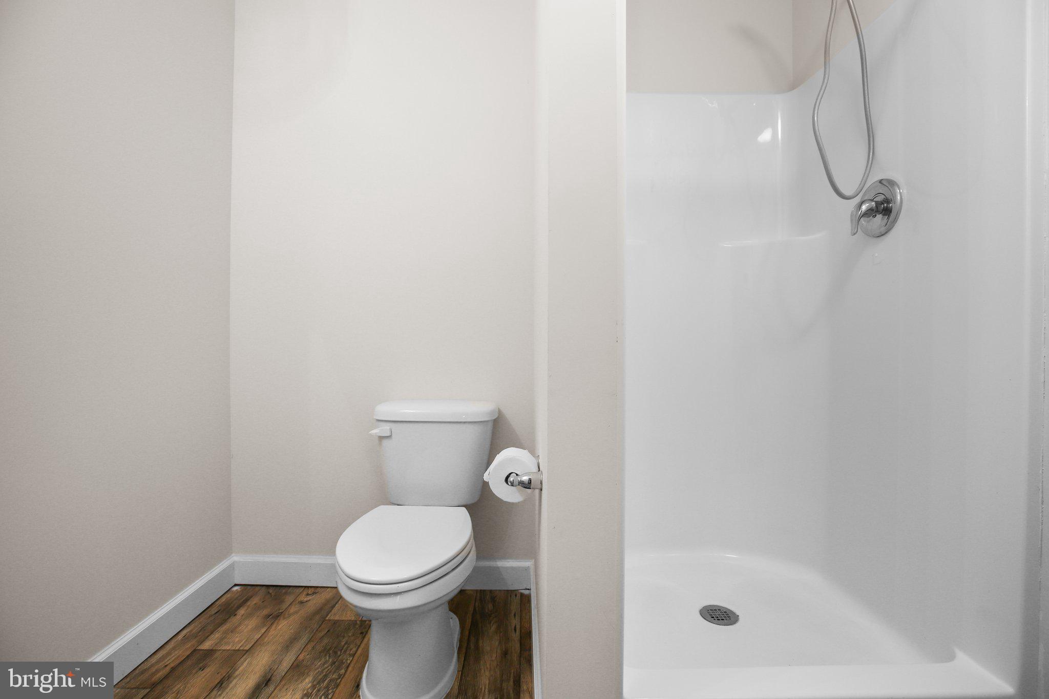 6337 Louisianna Road Locust Grove, VA 22508 - Photo 54 of 75 a white toilet sitting next to a bath tub and a shower