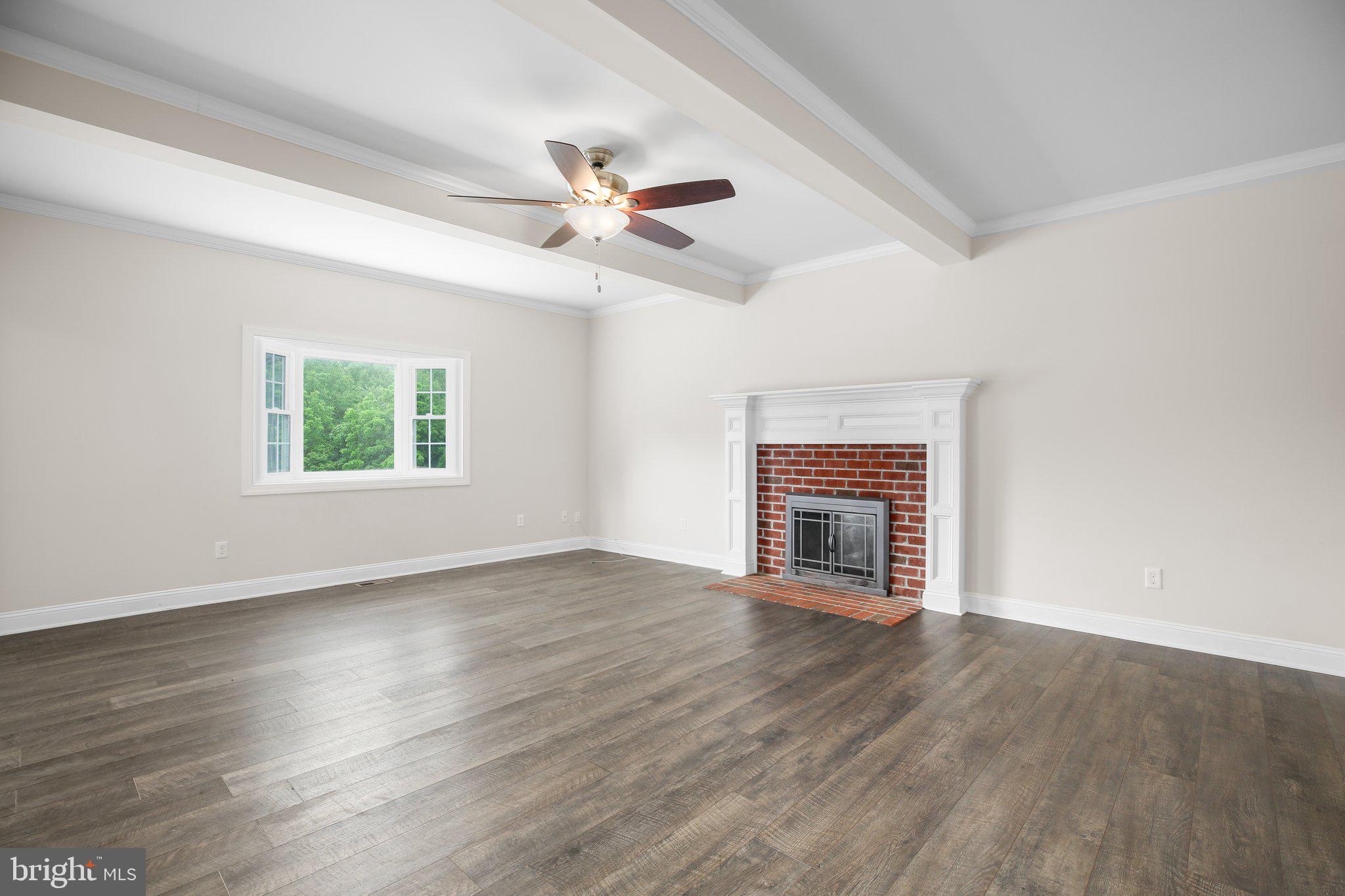 6337 Louisianna Road Locust Grove, VA 22508 - Photo 9 of 75 an empty room with wooden floor fireplace and windows