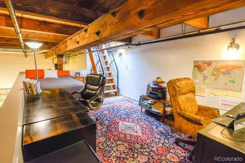 a view of a room with wooden floor and furniture