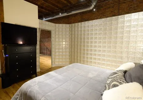 a bedroom with a bed and a television