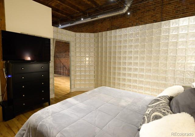 1450 Wynkoop Street, Unit 3F Denver, CO 80202 - Photo 5 of 29 a bedroom with a bed and a television