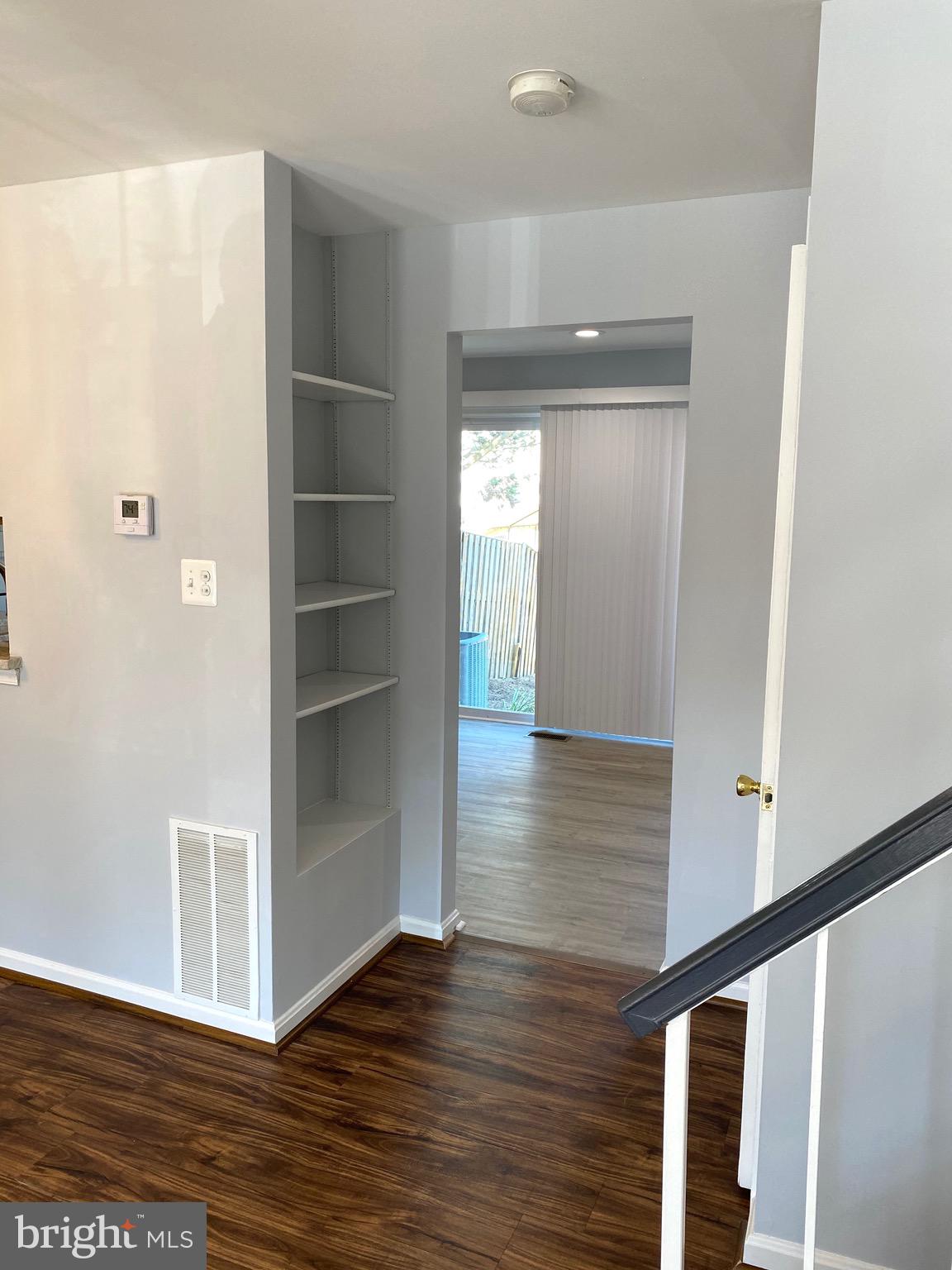 8081 Barcarole Court Springfield, VA 22153 - Photo 13 of 64 a view of a hallway with wooden floor