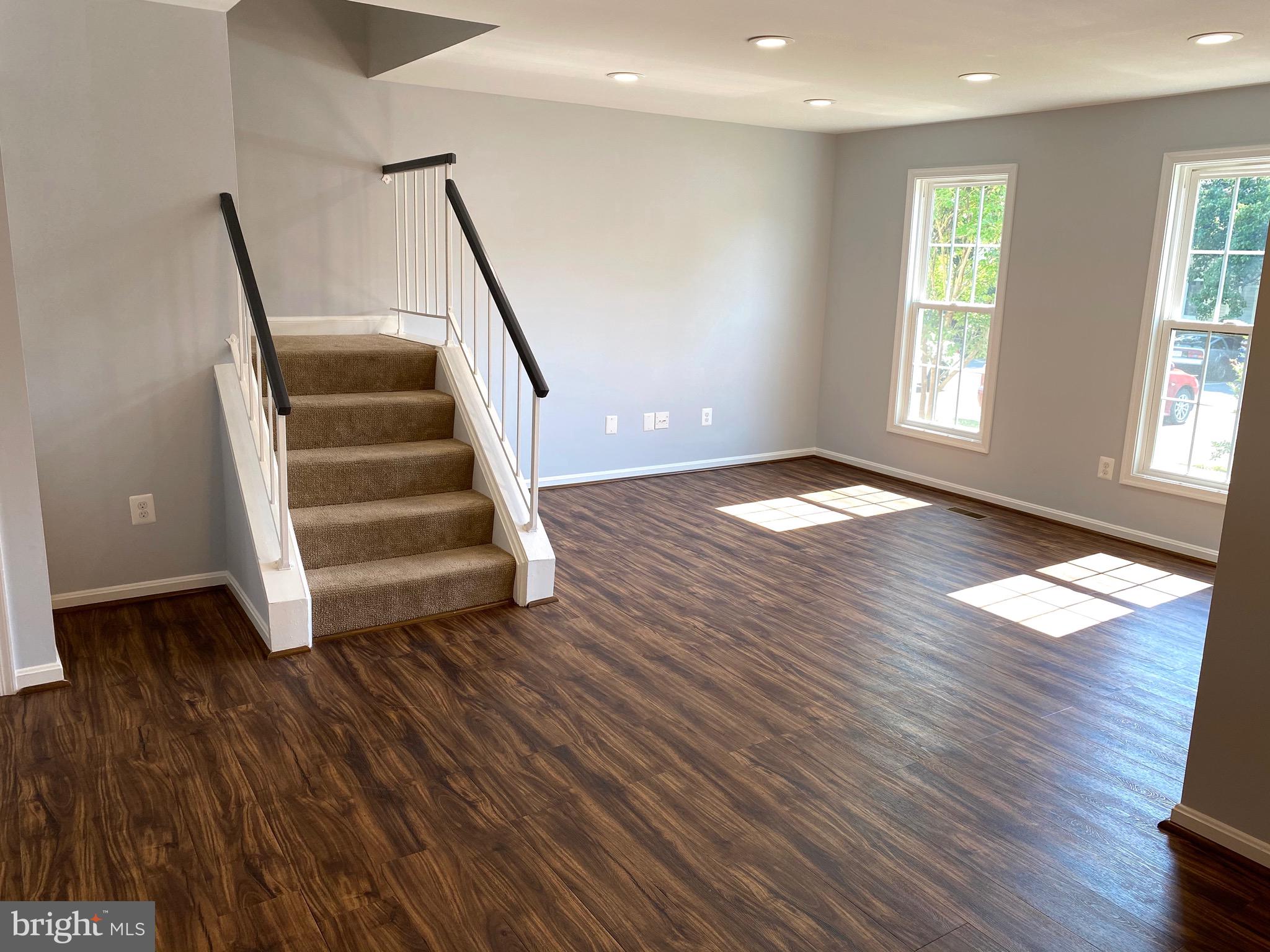 8081 Barcarole Court Springfield, VA 22153 - Photo 16 of 64 a view of an empty room with wooden floor and a window