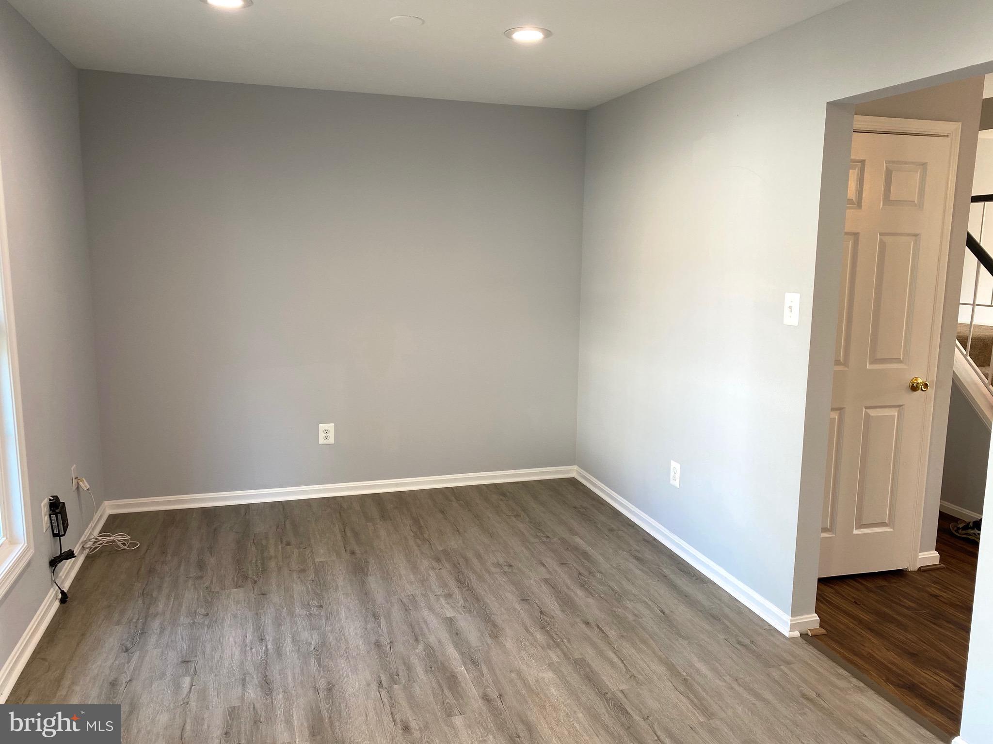 8081 Barcarole Court Springfield, VA 22153 - Photo 20 of 64 an empty room with wooden floor and entrance