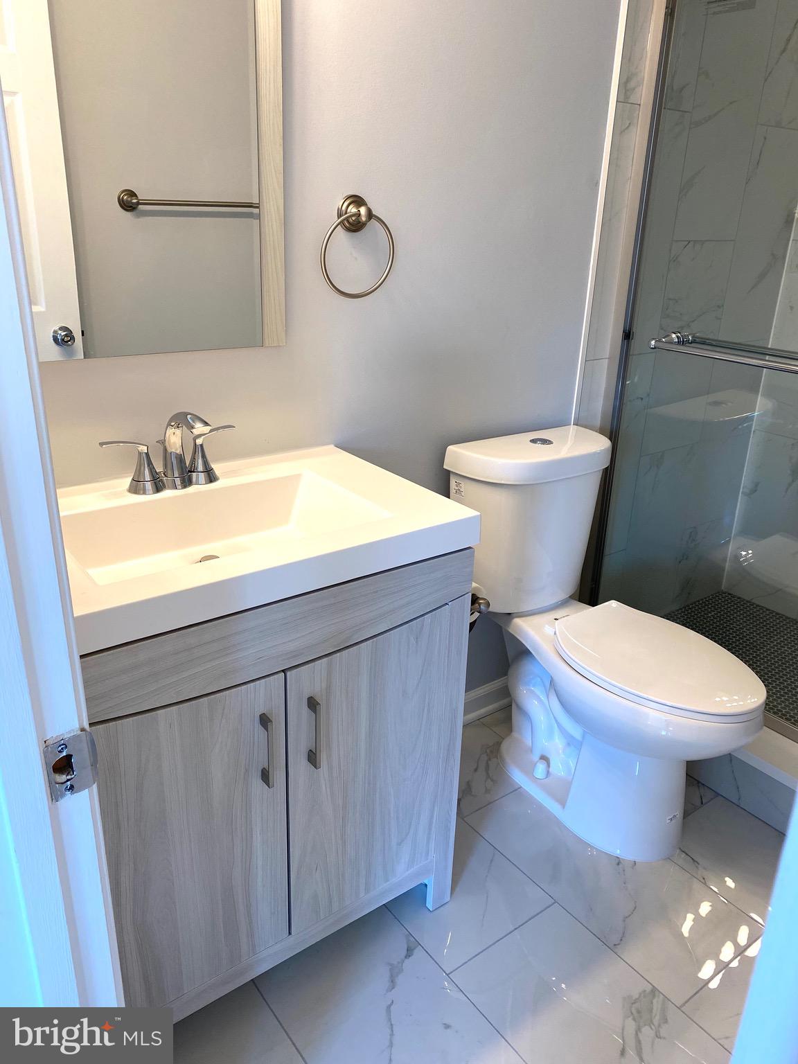 8081 Barcarole Court Springfield, VA 22153 - Photo 29 of 64 a bathroom with a sink a toilet and mirror