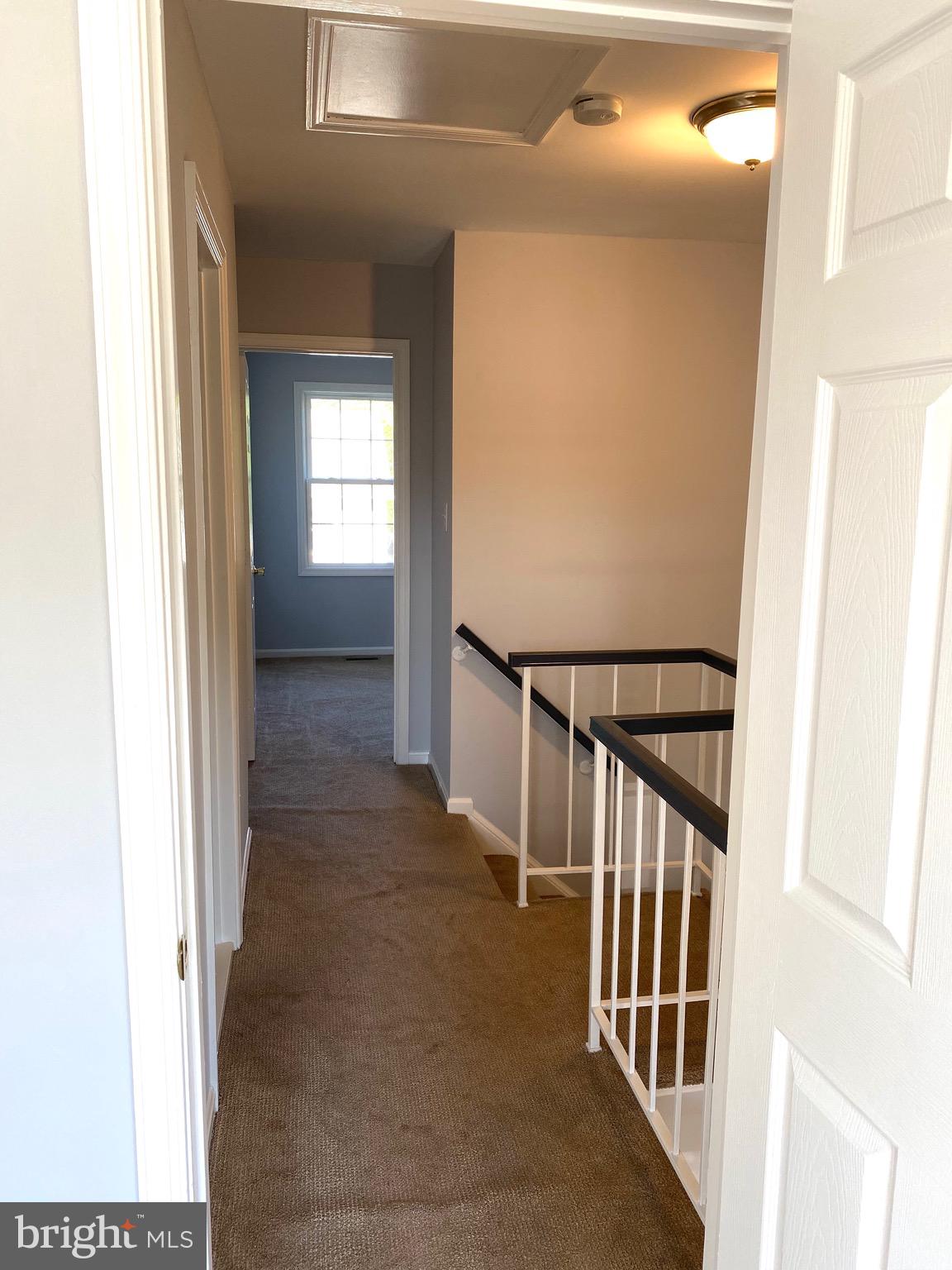 8081 Barcarole Court Springfield, VA 22153 - Photo 41 of 64 a view of a hallway with wooden floor and staircase