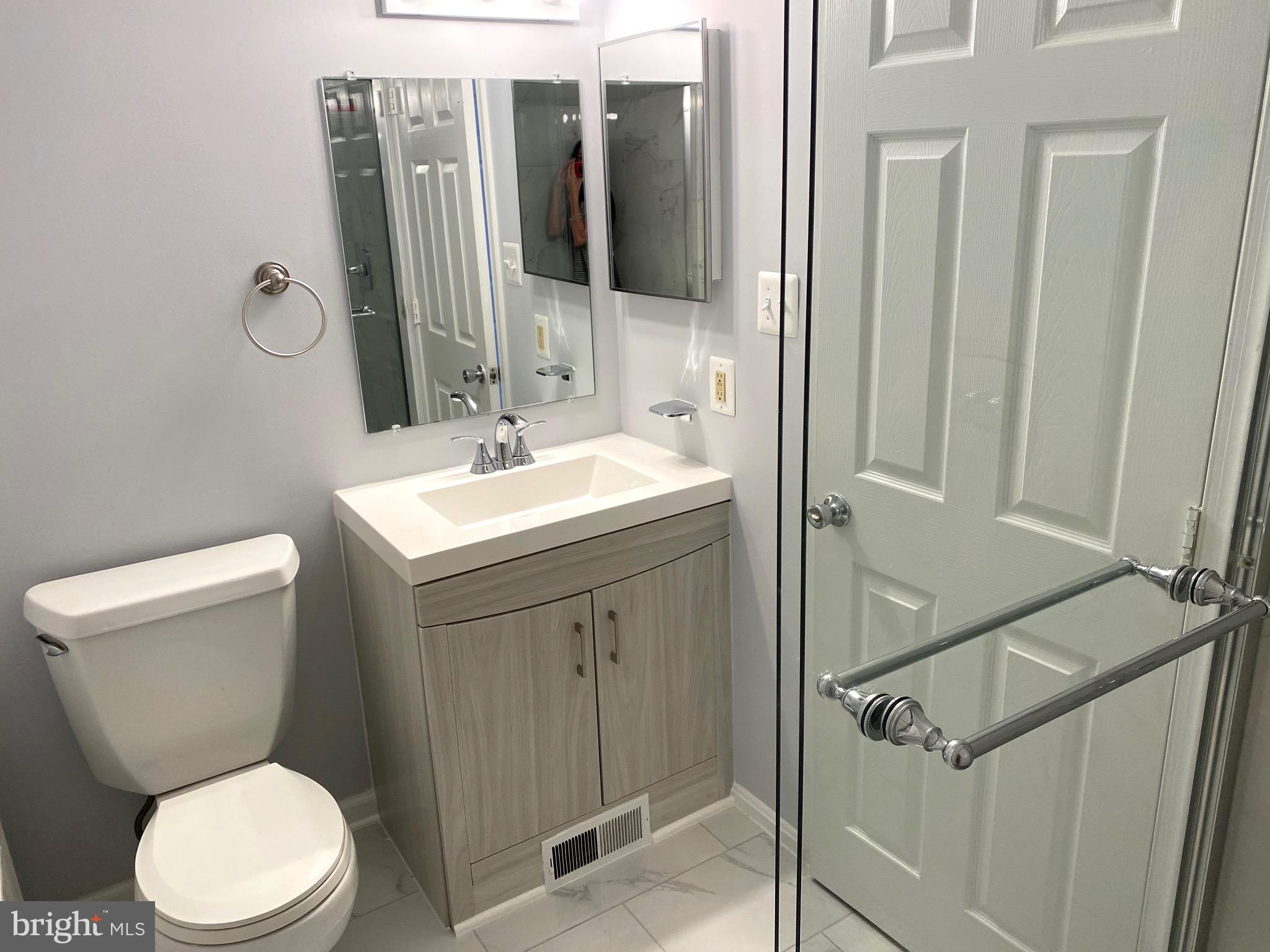 8081 Barcarole Court Springfield, VA 22153 - Photo 42 of 64 a bathroom with a toilet sink and mirror