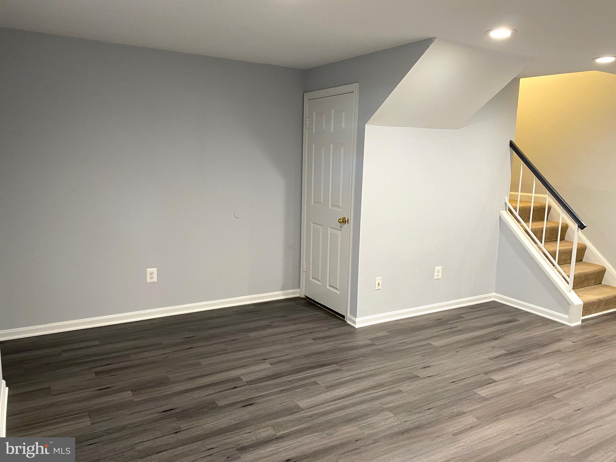 8081 Barcarole Court Springfield, VA 22153 - Photo 47 of 64 a view of an empty room with wooden floor