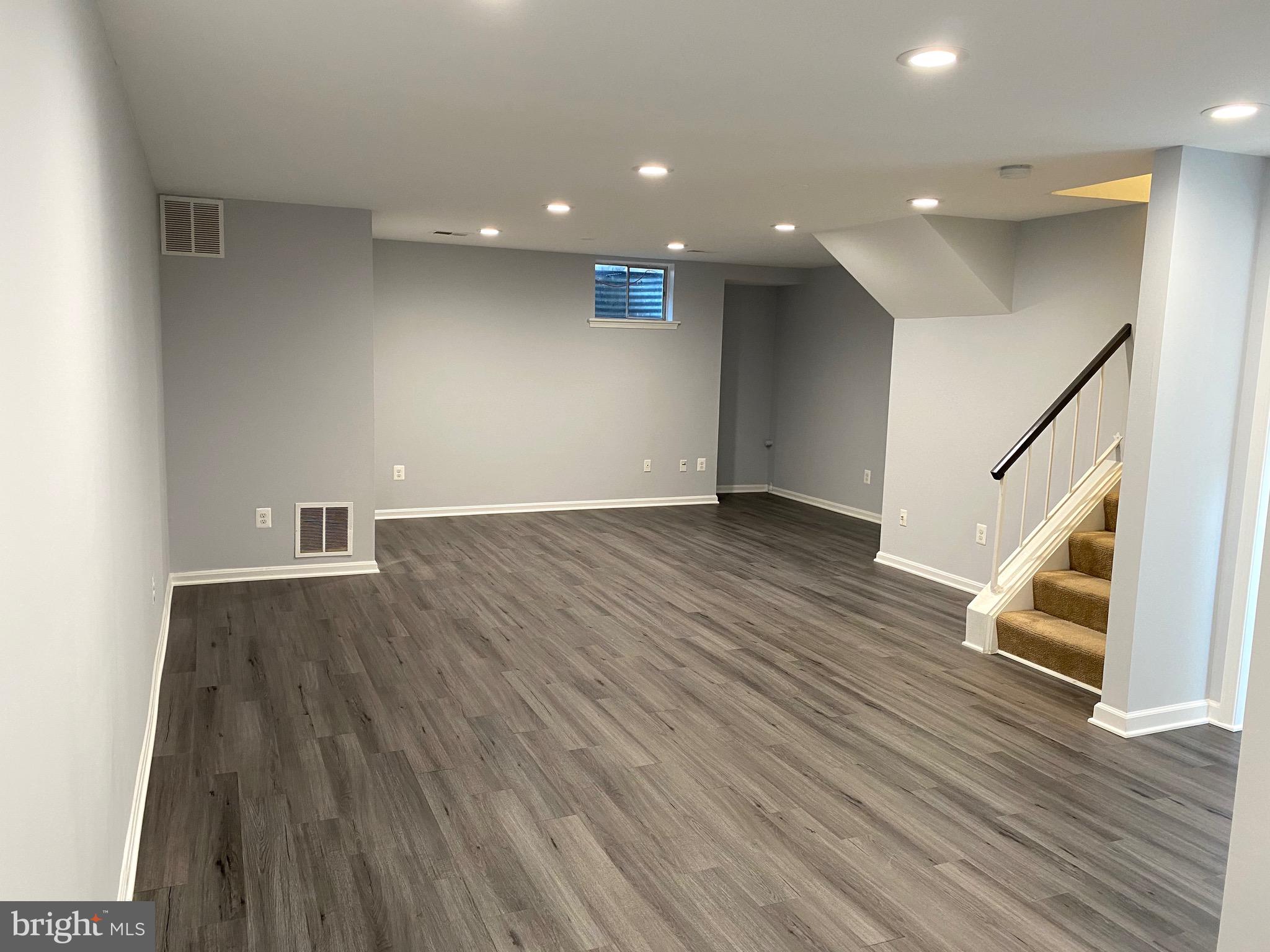 8081 Barcarole Court Springfield, VA 22153 - Photo 51 of 64 a view of an empty room with wooden floor and a window
