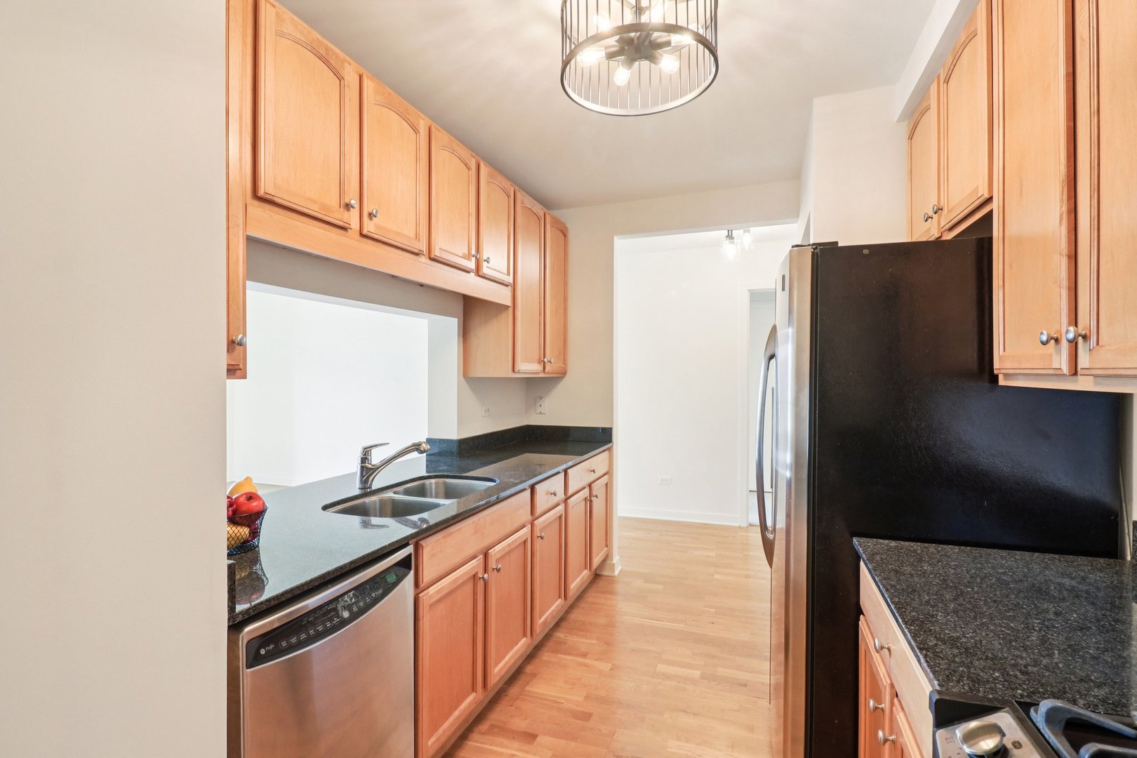 1160 South Michigan Avenue, Unit 2502 Chicago, IL 60605 - Photo 13 of 44 a kitchen with stainless steel appliances granite countertop a refrigerator and a stove