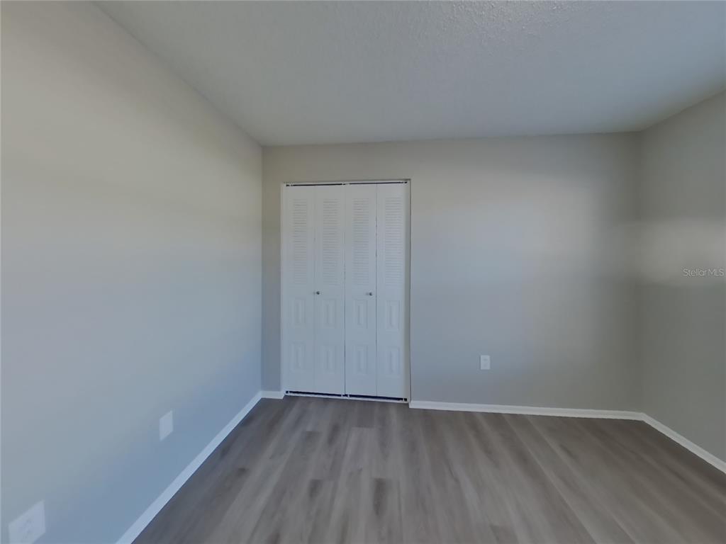 Undisclosed Address Brandon, FL 33511 - Photo 12 of 18 a view of an empty room and wooden floor