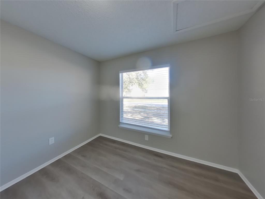 Undisclosed Address Brandon, FL 33511 - Photo 13 of 18 an empty room with wooden floor and windows
